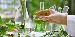 Micellar skincare -chemist hand with green liquid flask